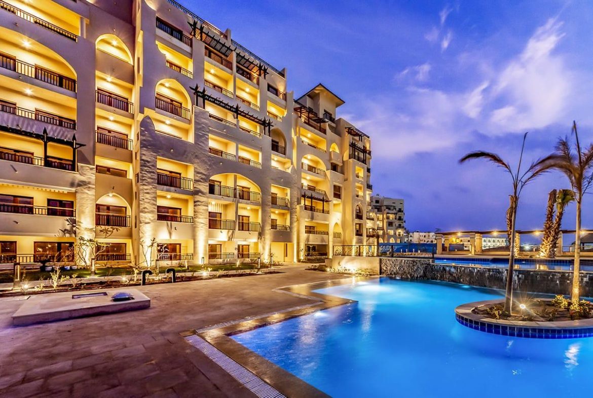 ALDAU Heights Hurghada swimming pool and golden apartment facade