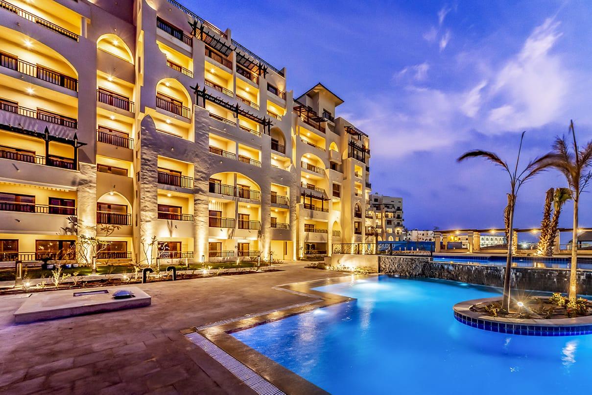 ALDAU Heights Hurghada swimming pool and golden apartment facade